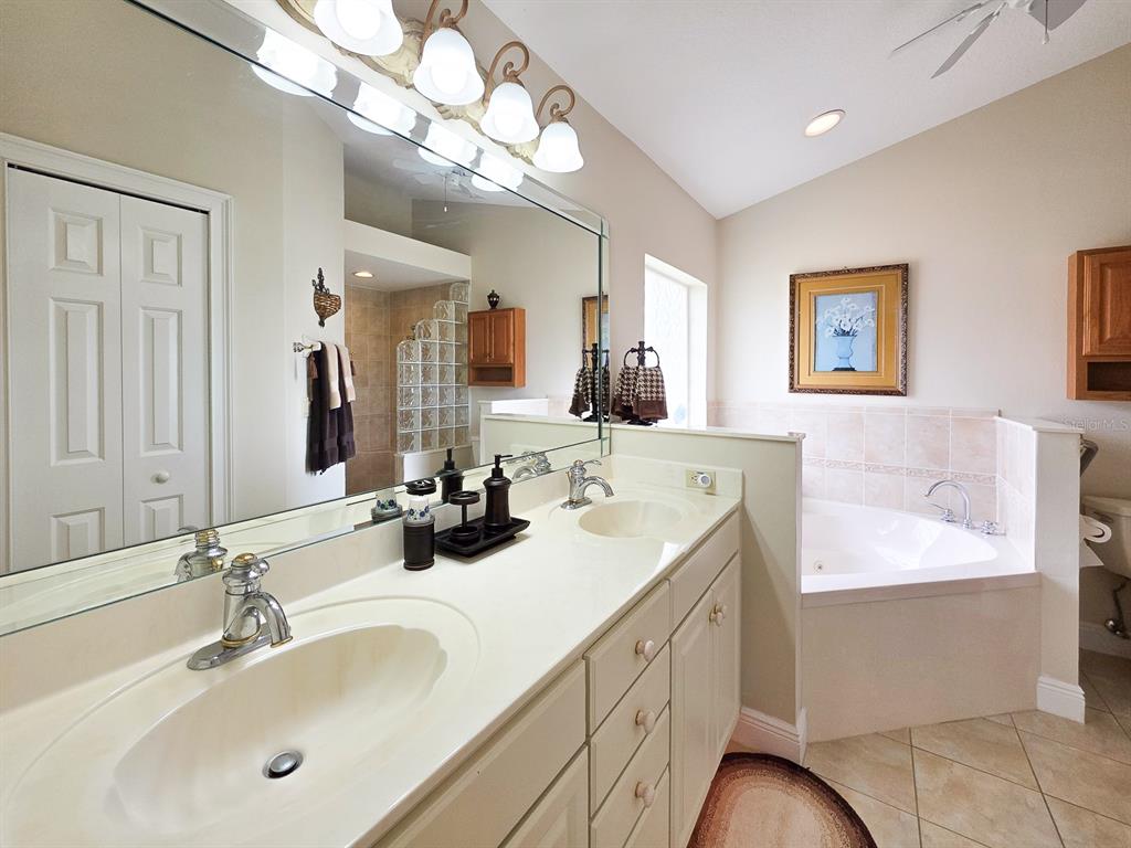 1 Ripley Place Palm Coast, FL 32164 - Photo 27 of 54 a bathroom with a sink vanity and a mirror