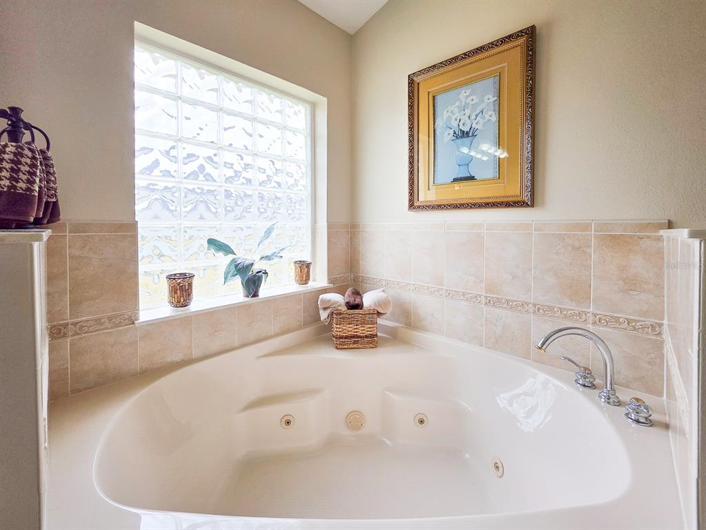 1 Ripley Place Palm Coast, FL 32164 - Photo 29 of 54 a bathroom with a tub a sink and a window