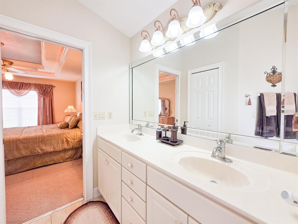 1 Ripley Place Palm Coast, FL 32164 - Photo 31 of 54 a en suite bathroom with double sink and a mirror