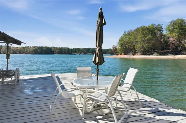 a view of a lake with a table and chairs