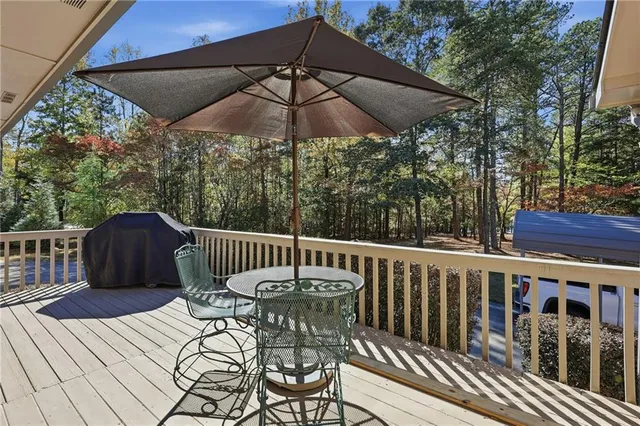 a view of a chair and tables in the balcony