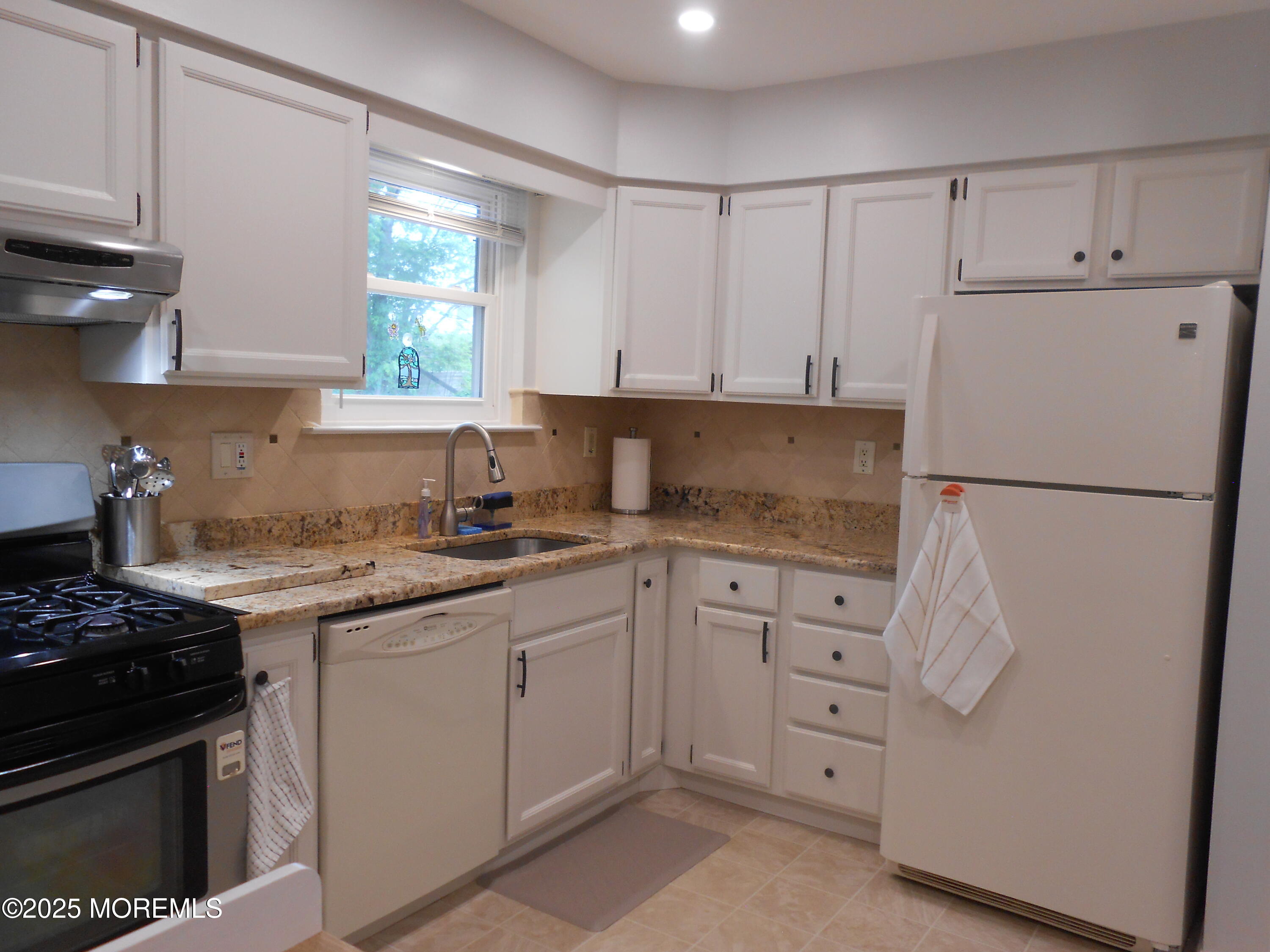 603 Bloomfield Drive Westampton, NJ 08060 - Photo 32 of 66 a kitchen with white cabinets and white appliances