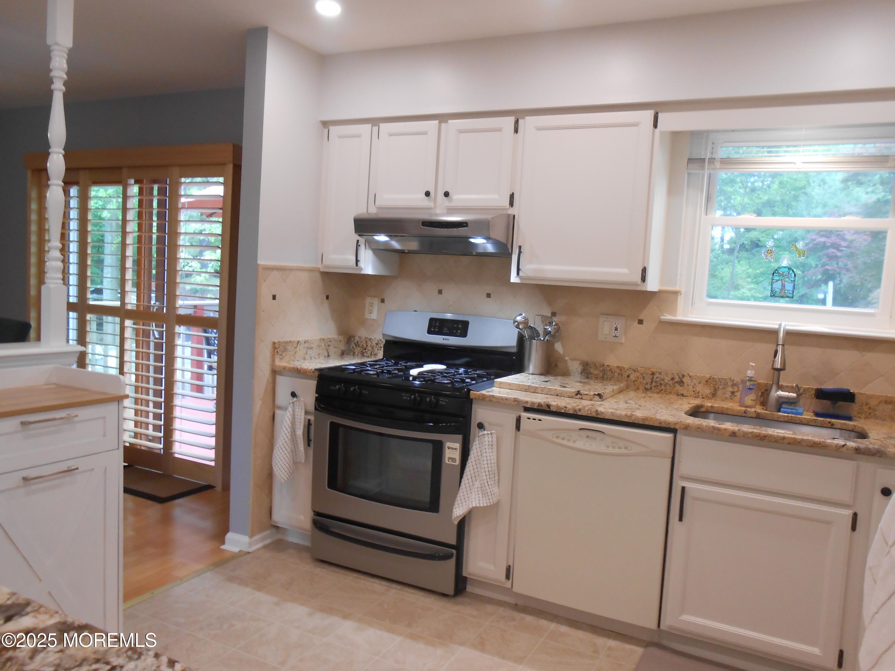 603 Bloomfield Drive Westampton, NJ 08060 - Photo 36 of 66 a kitchen with granite countertop white cabinets and white appliances