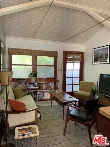 a living room with furniture and a floor to ceiling window