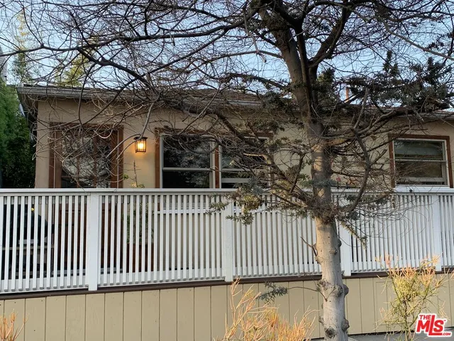 a side view of a house with a street