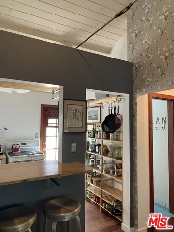 a room with furniture a air conditioner and a stove