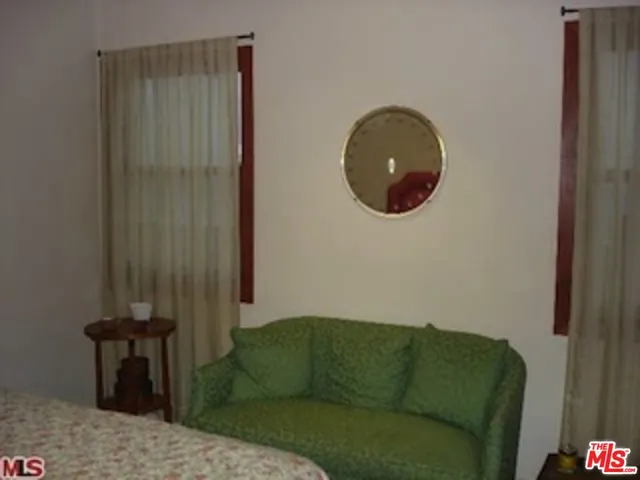 a living room with furniture and a mirror