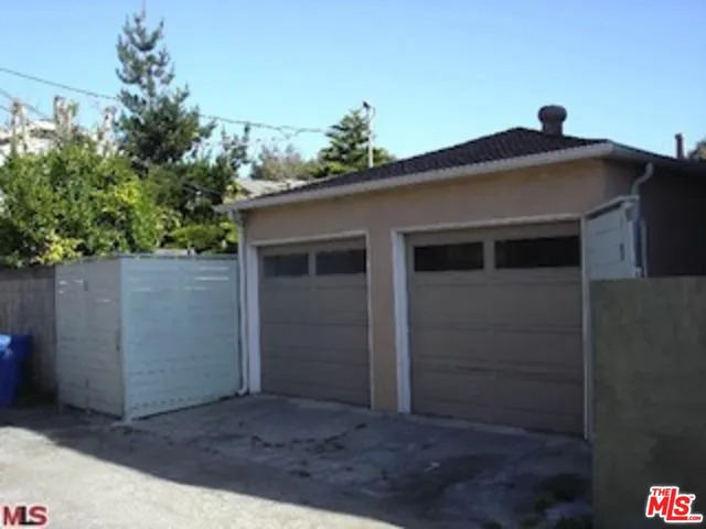 a view of a house with a small yard and wooden fence