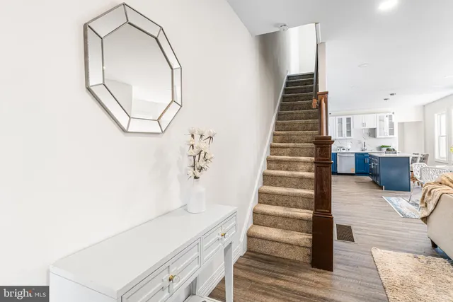 a view of entryway and hall with wooden floor