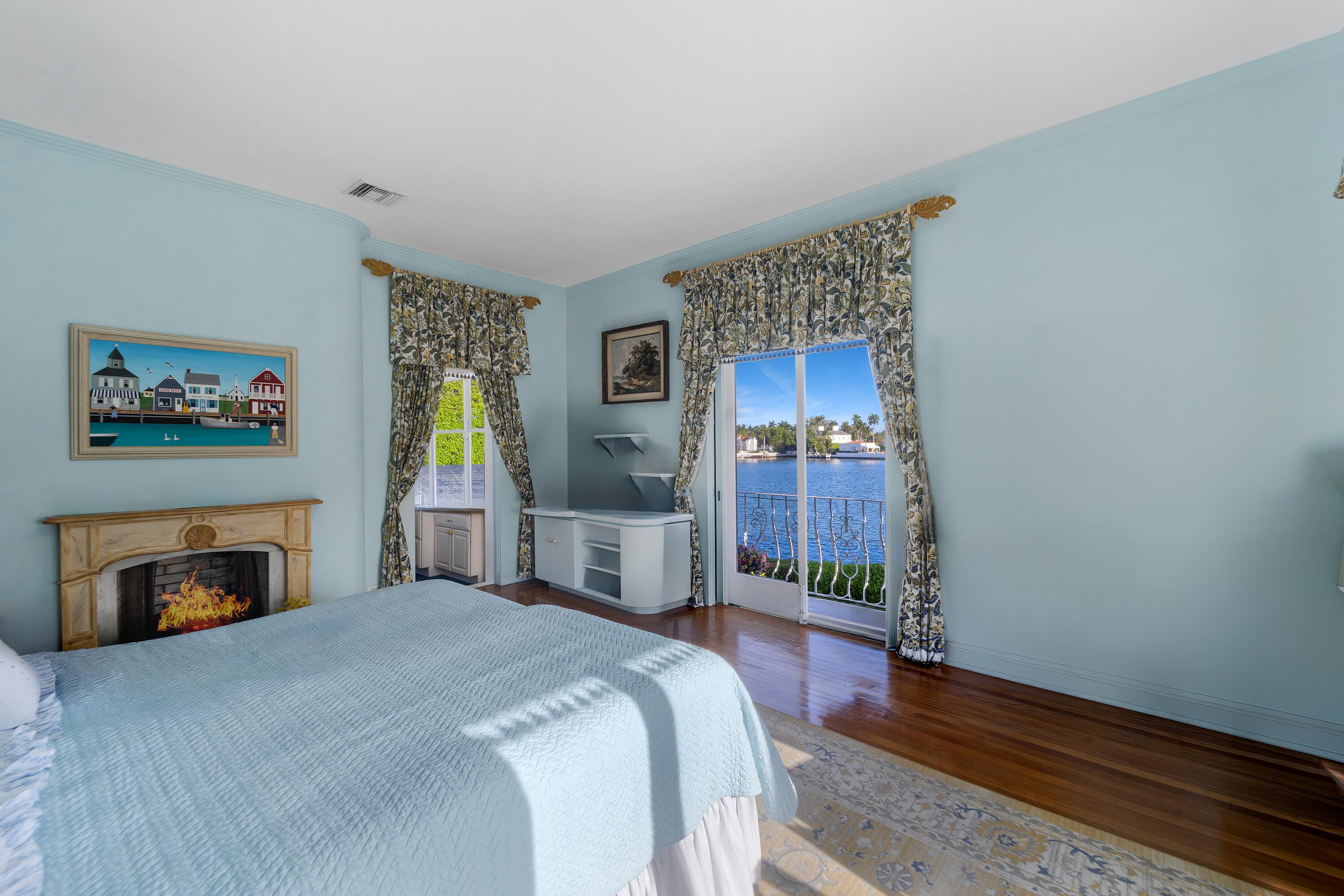 350 Island Road Palm Beach, FL 33480 - Photo 18 of 26 a bedroom with a bed and a fireplace