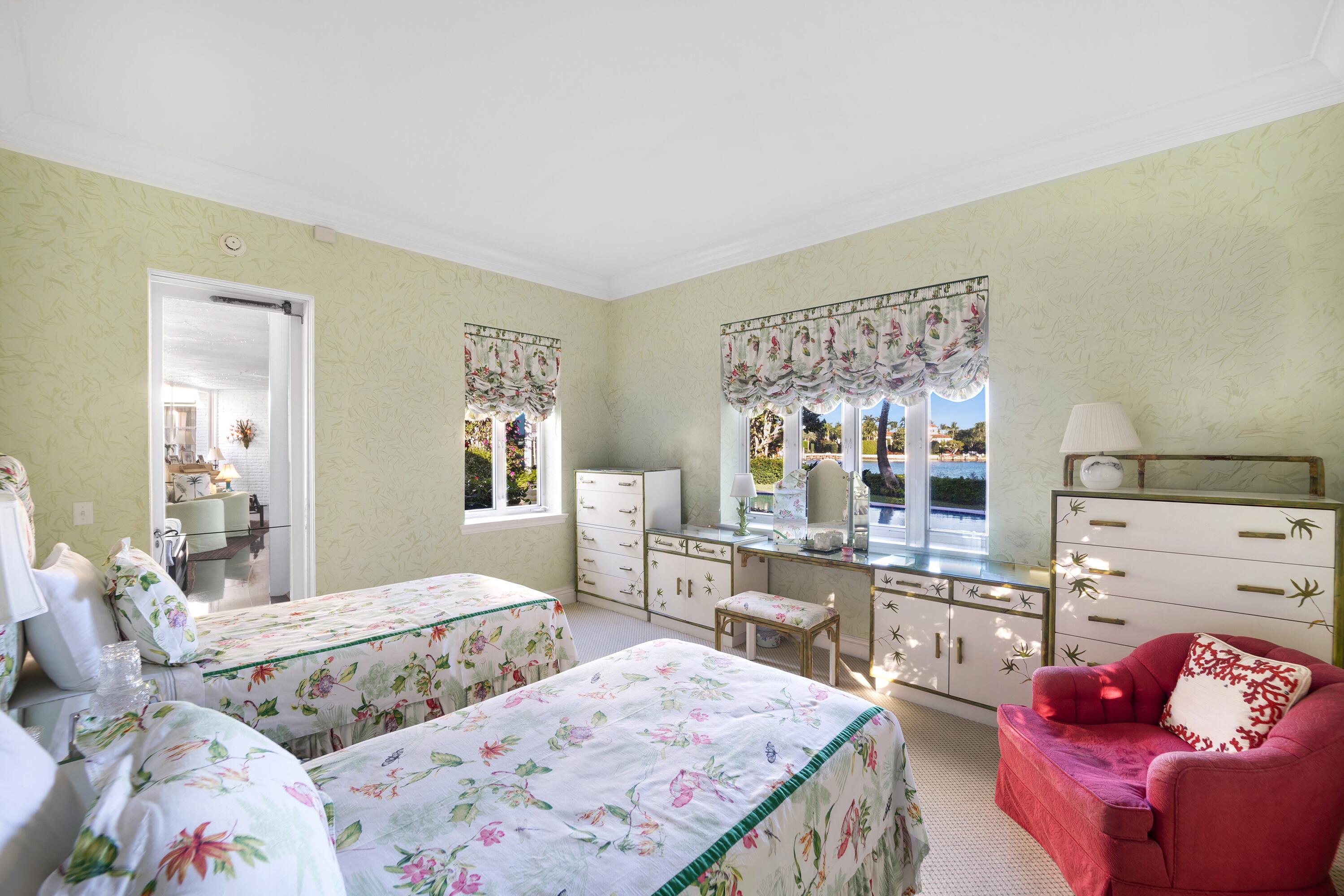 350 Island Road Palm Beach, FL 33480 - Photo 22 of 26 a bedroom with a bed and wooden floor