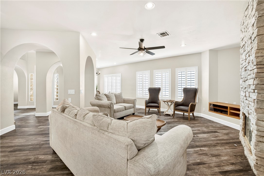 1135 Calico Ridge Drive Henderson, NV 89011 - Photo 18 of 86 Recessed lighting and a stylish ceiling fan illuminate this inviting living area with a captivating stone fireplace.