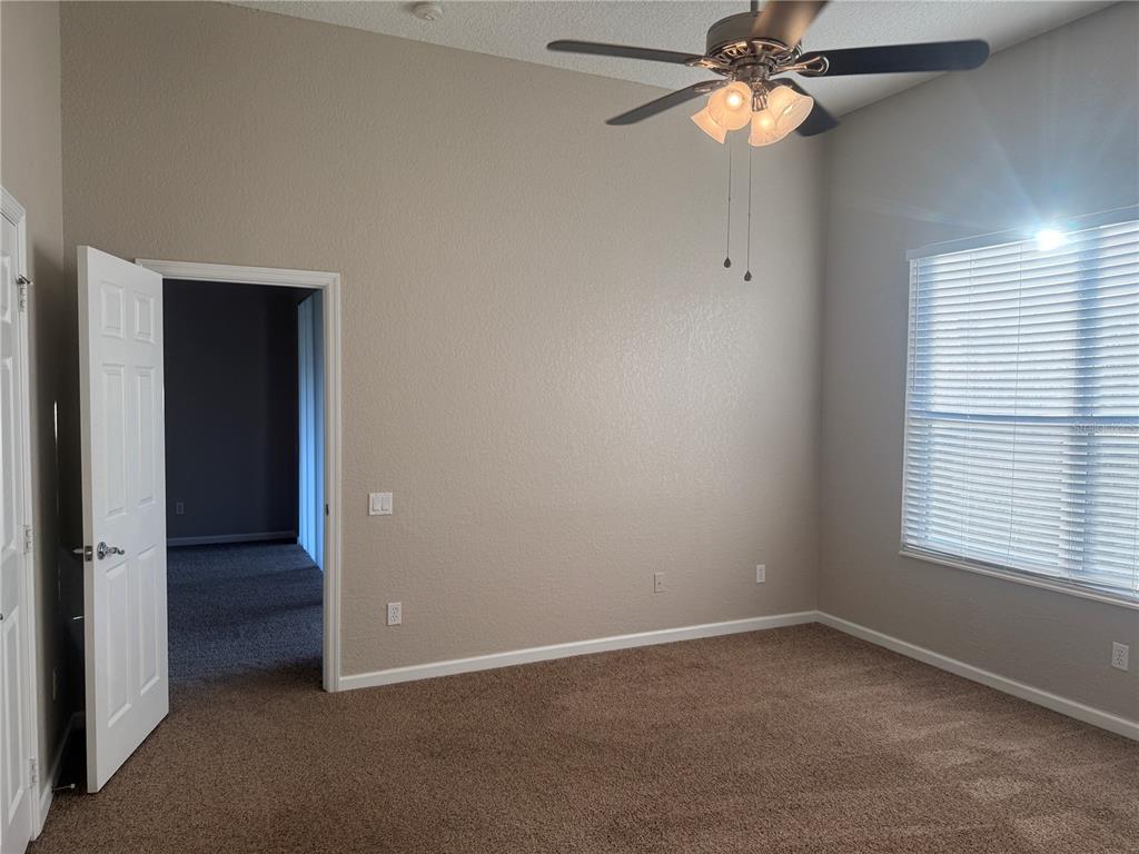 1100 Brant Point Orlando, FL 32828 - Photo 12 of 26 an empty room with a window and a fan
