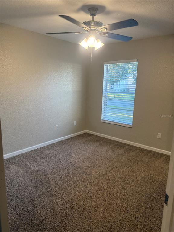 1100 Brant Point Orlando, FL 32828 - Photo 16 of 26 an empty room with windows and fan