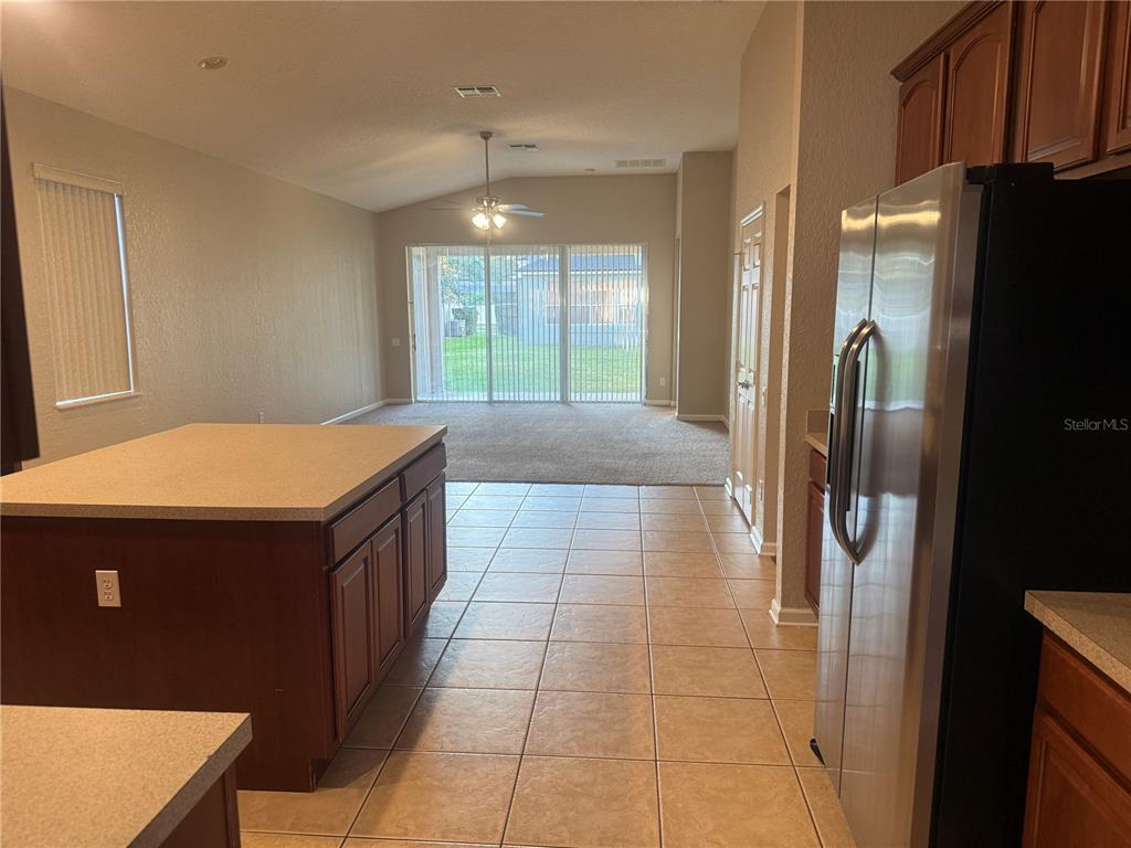 1100 Brant Point Orlando, FL 32828 - Photo 4 of 26 a kitchen with stainless steel appliances granite countertop a refrigerator and a stove