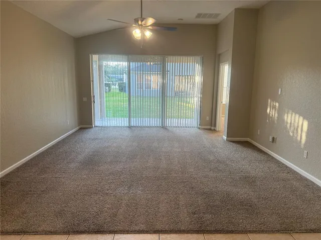 a view of an empty room with glass door