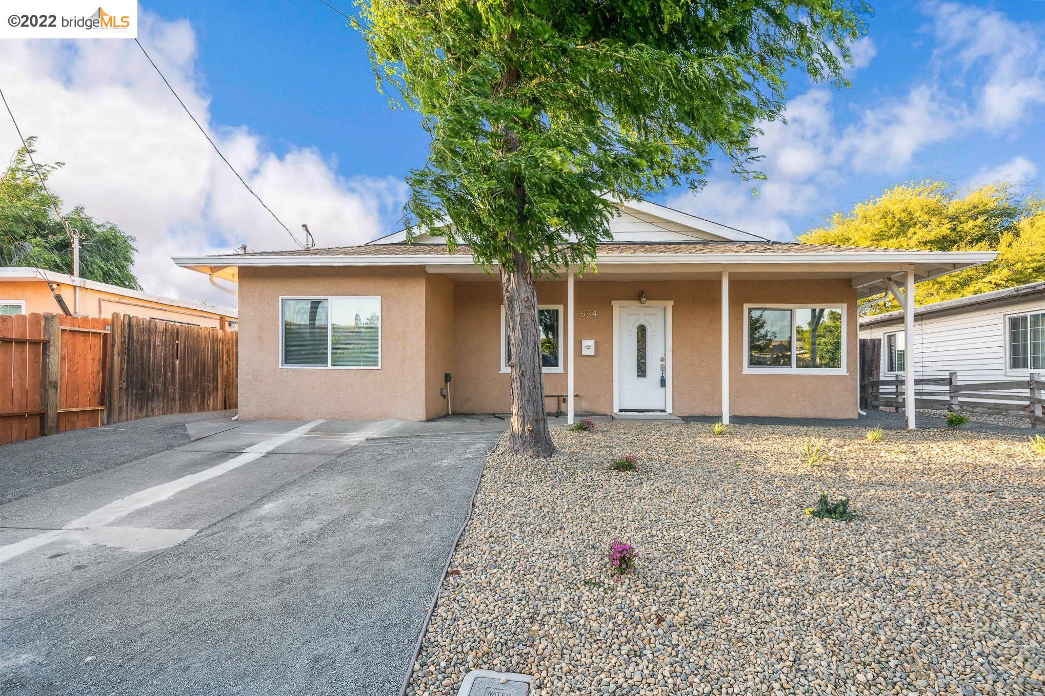 Shore Acres Bay Point, CA 94565 - Photo 1 of 1 a front view of a house with a yard and garage