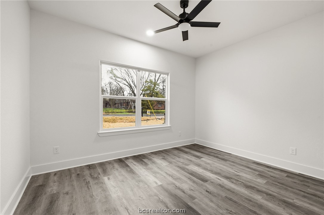205 Lock Lane Bryan, TX 77803 - Photo 12 of 23 an empty room with a window and a ceiling fan