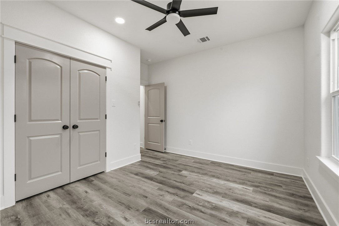 205 Lock Lane Bryan, TX 77803 - Photo 13 of 23 a view of a room with wooden floor and white walls