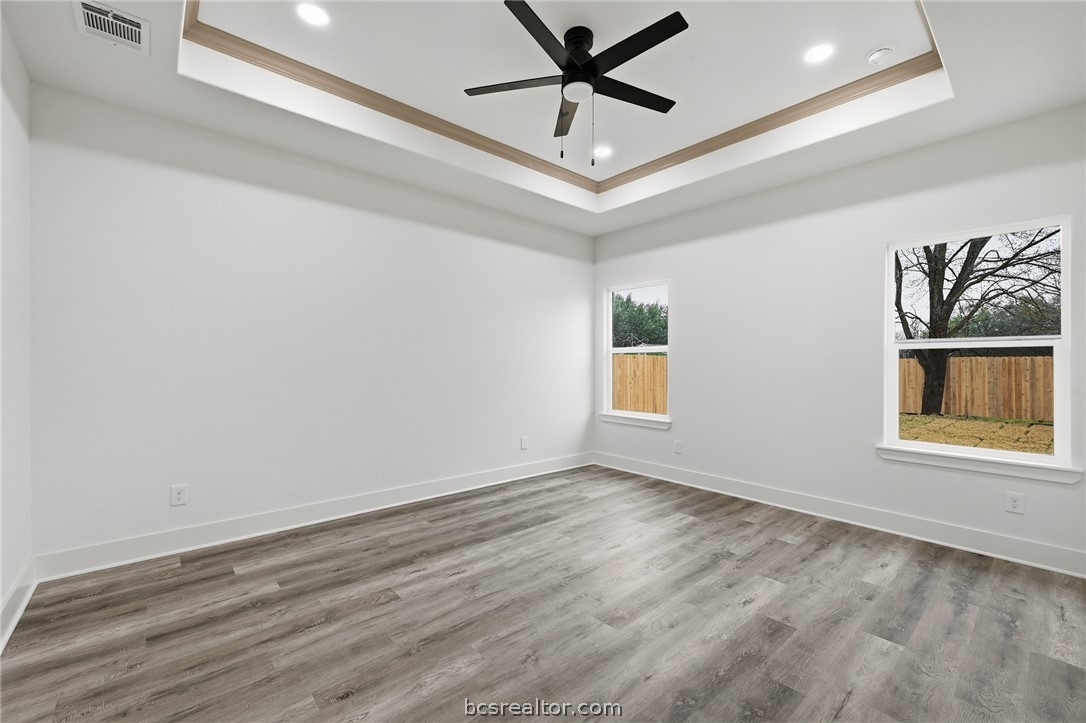 205 Lock Lane Bryan, TX 77803 - Photo 17 of 23 wooden floor in an empty room with a window