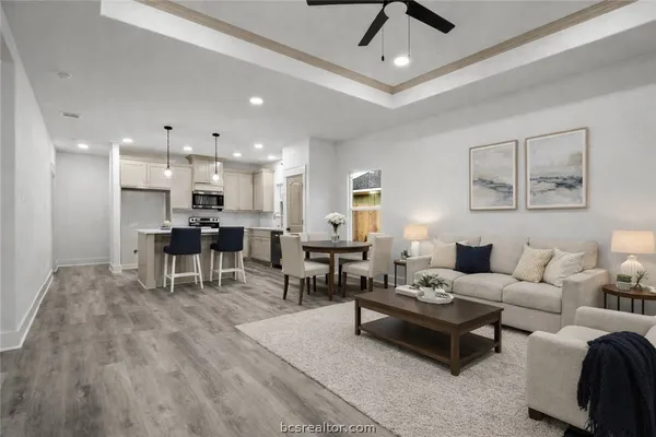 a living room with furniture and kitchen view