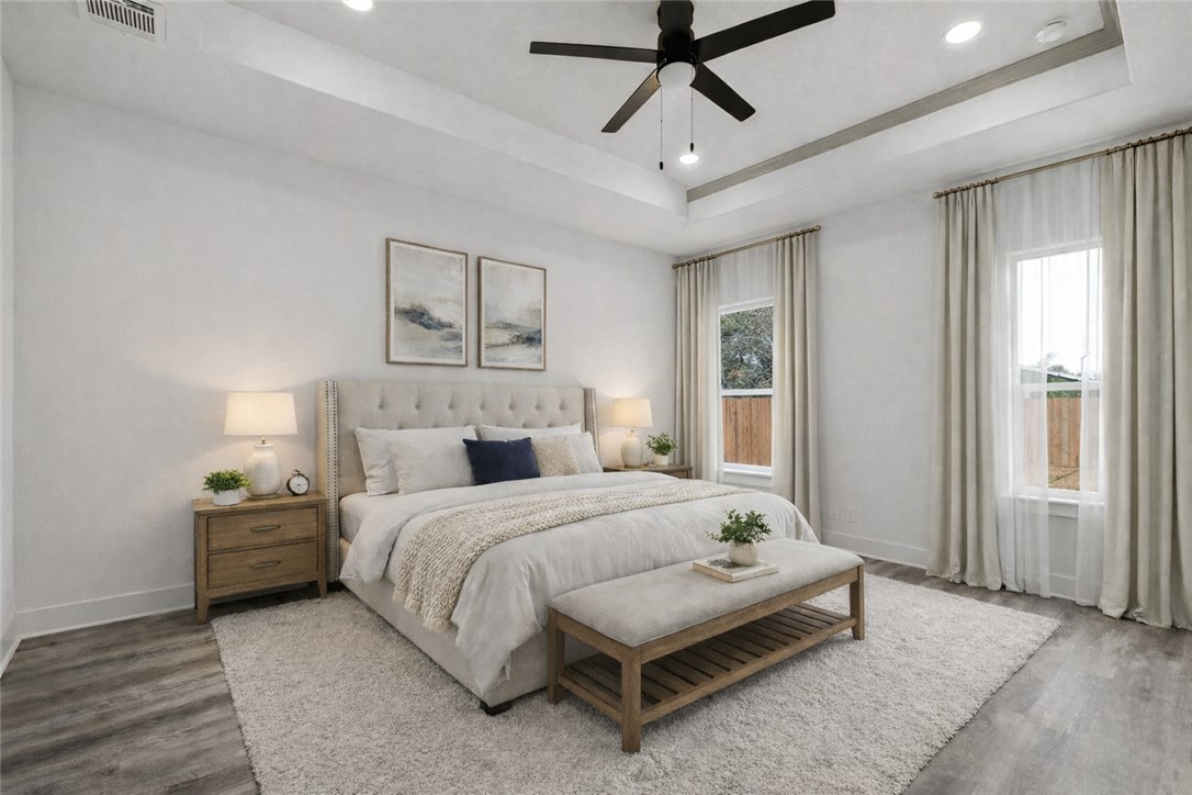 205 Lock Lane Bryan, TX 77803 - Photo 6 of 23 a bedroom with a bed chandelier and a window