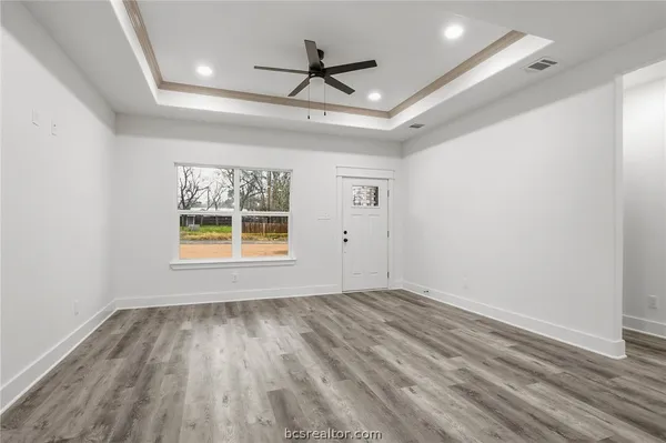 wooden floor in an empty room with a window