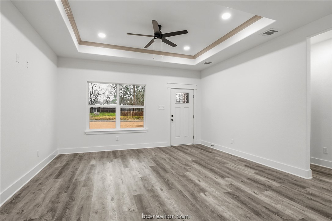 205 Lock Lane Bryan, TX 77803 - Photo 8 of 23 wooden floor in an empty room with a window