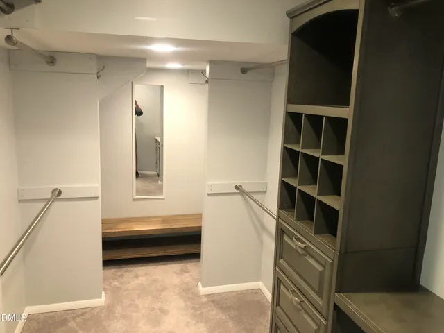 a view of walk in closet and window