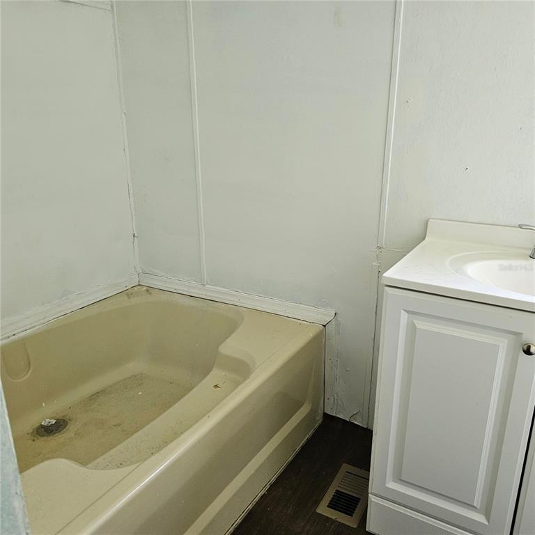 2603 Ince Drive Ruskin, FL 33570 - Photo 6 of 10 a bath tub sitting next to a white sink and vanity