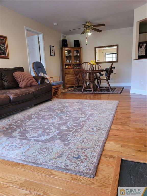 2705 Ridgefield Court, Unit 2705 Helmetta, NJ 08828 - Photo 12 of 33 a living room with furniture and wooden floor