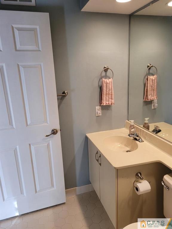 2705 Ridgefield Court, Unit 2705 Helmetta, NJ 08828 - Photo 14 of 33 a bathroom with a sink and mirror