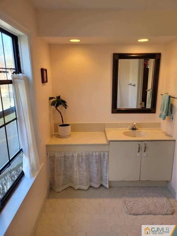 2705 Ridgefield Court, Unit 2705 Helmetta, NJ 08828 - Photo 17 of 33 a bathroom with a sink a mirror and vanity