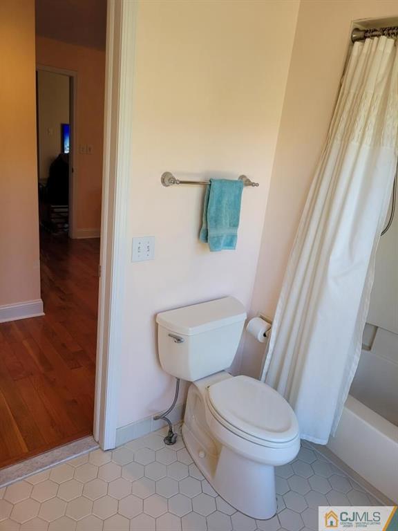 2705 Ridgefield Court, Unit 2705 Helmetta, NJ 08828 - Photo 18 of 33 a white toilet sitting next to a small bathroom