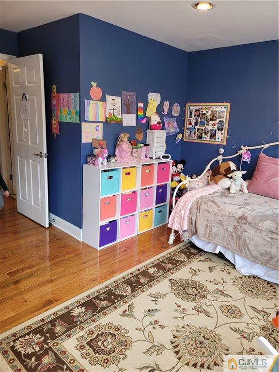 2705 Ridgefield Court, Unit 2705 Helmetta, NJ 08828 - Photo 22 of 33 a bedroom with a bed and wooden floor