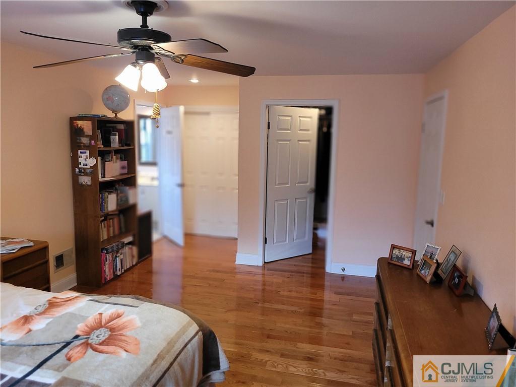 2705 Ridgefield Court, Unit 2705 Helmetta, NJ 08828 - Photo 28 of 33 a bedroom with a bed and wooden floor