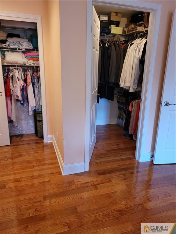 2705 Ridgefield Court, Unit 2705 Helmetta, NJ 08828 - Photo 29 of 33 a view of walk in closet with clothes and shoes