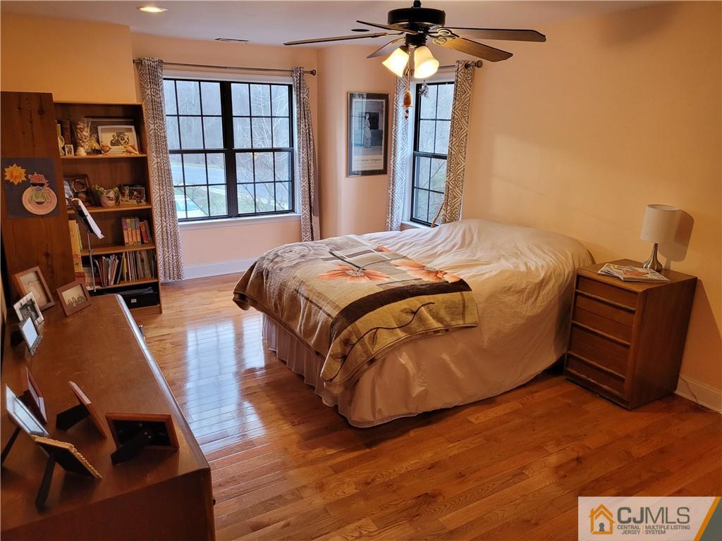 2705 Ridgefield Court, Unit 2705 Helmetta, NJ 08828 - Photo 30 of 33 a bedroom with a bed and wooden floor