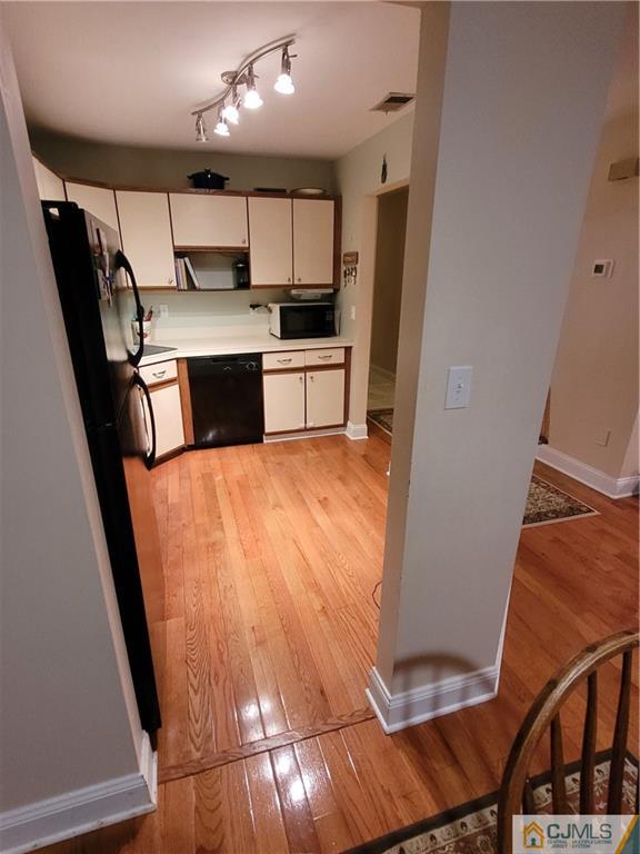 2705 Ridgefield Court, Unit 2705 Helmetta, NJ 08828 - Photo 4 of 33 a kitchen with stainless steel appliances a refrigerator a sink a stove a microwave and cabinets