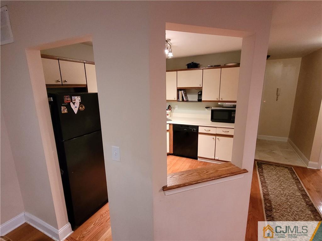 2705 Ridgefield Court, Unit 2705 Helmetta, NJ 08828 - Photo 6 of 33 a kitchen with stainless steel appliances cabinets and a counter top space