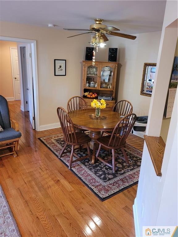 2705 Ridgefield Court, Unit 2705 Helmetta, NJ 08828 - Photo 9 of 33 a view of a dining room with furniture and wooden floor