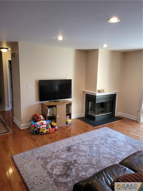 2705 Ridgefield Court, Unit 2705 Helmetta, NJ 08828 - Photo 10 of 33 a living room with furniture and a flat screen tv
