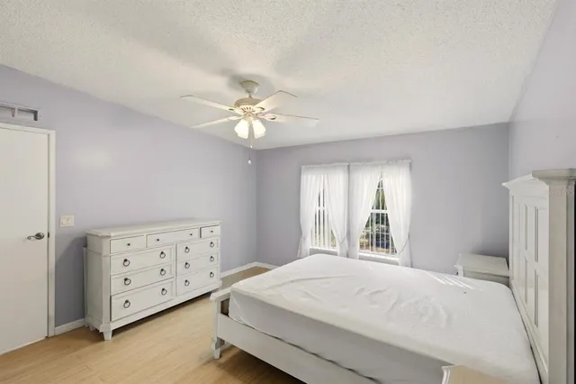 a bathroom with a sink a toilet a mirror and shower