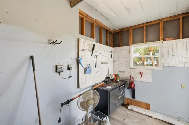 a view of a house with backyard and a tree