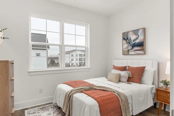 a bedroom with a bed and lamp