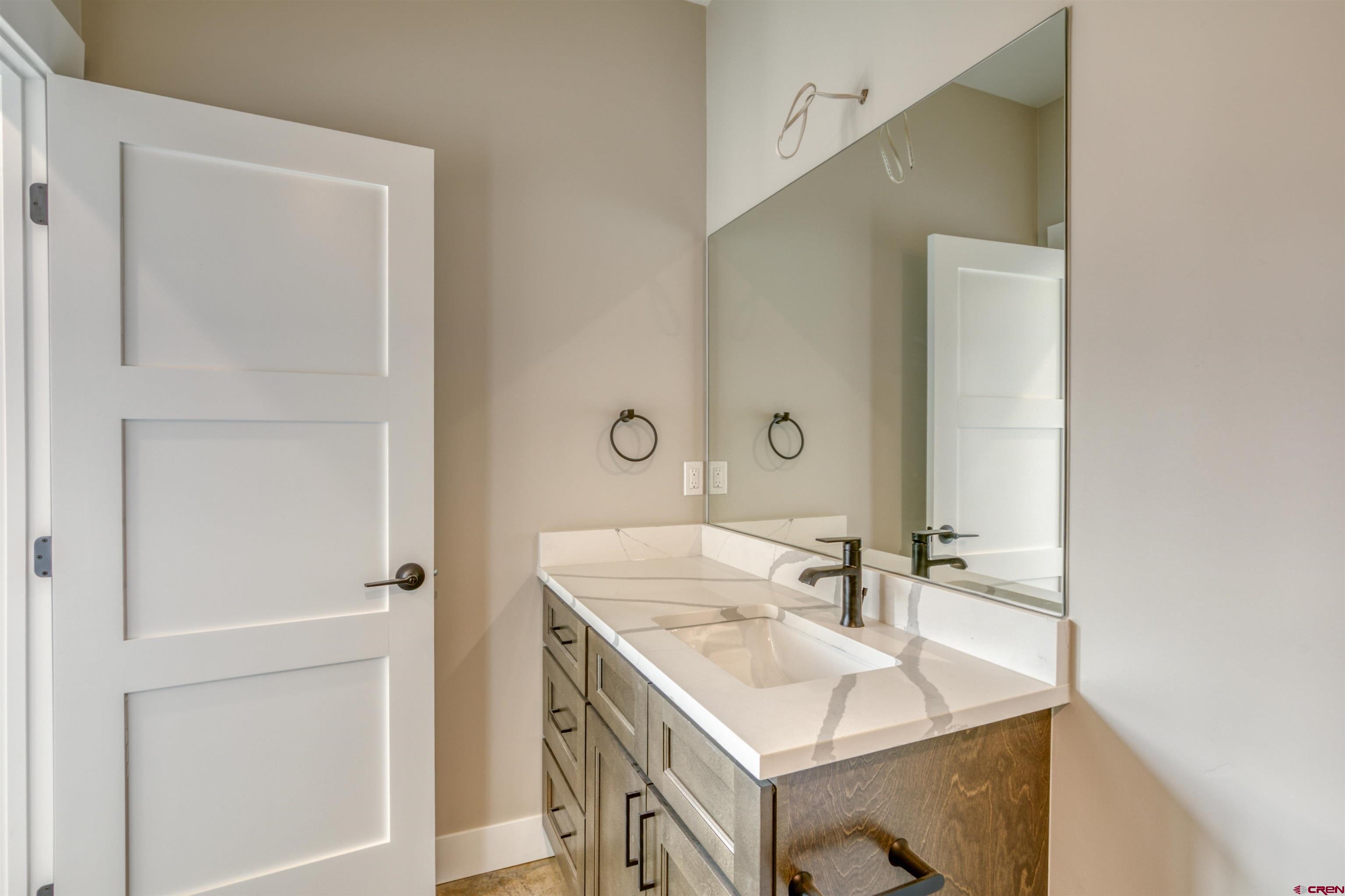 2790 Rock Road, Unit F Pagosa Springs, CO 81147 - Photo 28 of 45 a bathroom with a sink vanity and a mirror