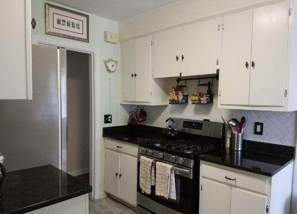 1677 Geraldine Drive Jacksonville, FL 32205 - Photo 17 of 52 a kitchen with stainless steel appliances granite countertop a stove and a refrigerator