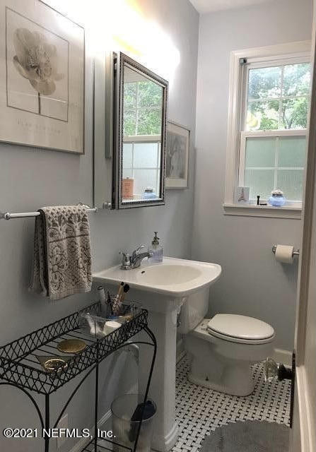 1677 Geraldine Drive Jacksonville, FL 32205 - Photo 22 of 52 a bathroom with a sink a toilet and a window