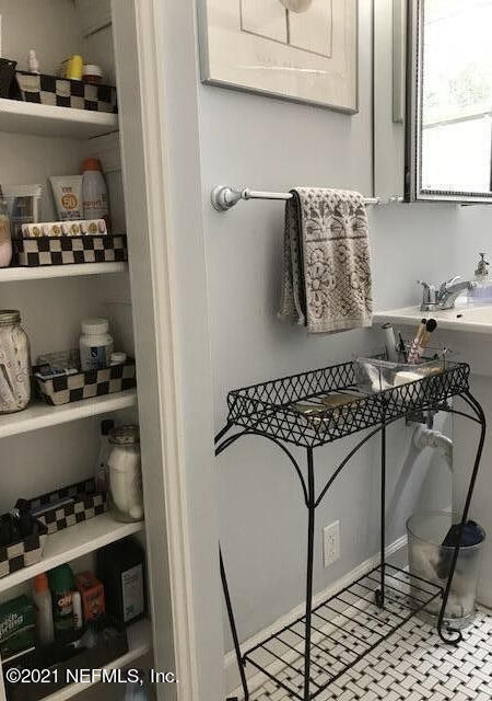 1677 Geraldine Drive Jacksonville, FL 32205 - Photo 23 of 52 a kitchen with a cabinets and window