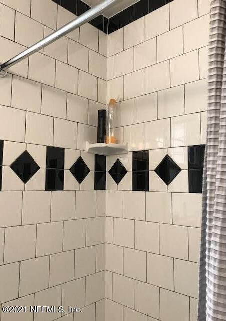 1677 Geraldine Drive Jacksonville, FL 32205 - Photo 25 of 52 a bathroom with a black and white checkered floor
